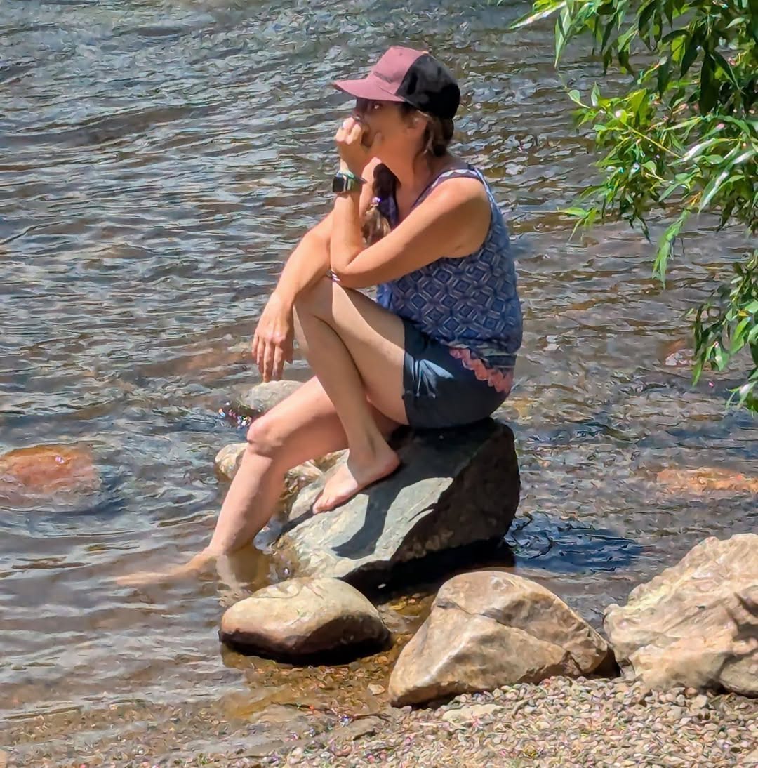 Andy sitting by the creek, thinking man pose